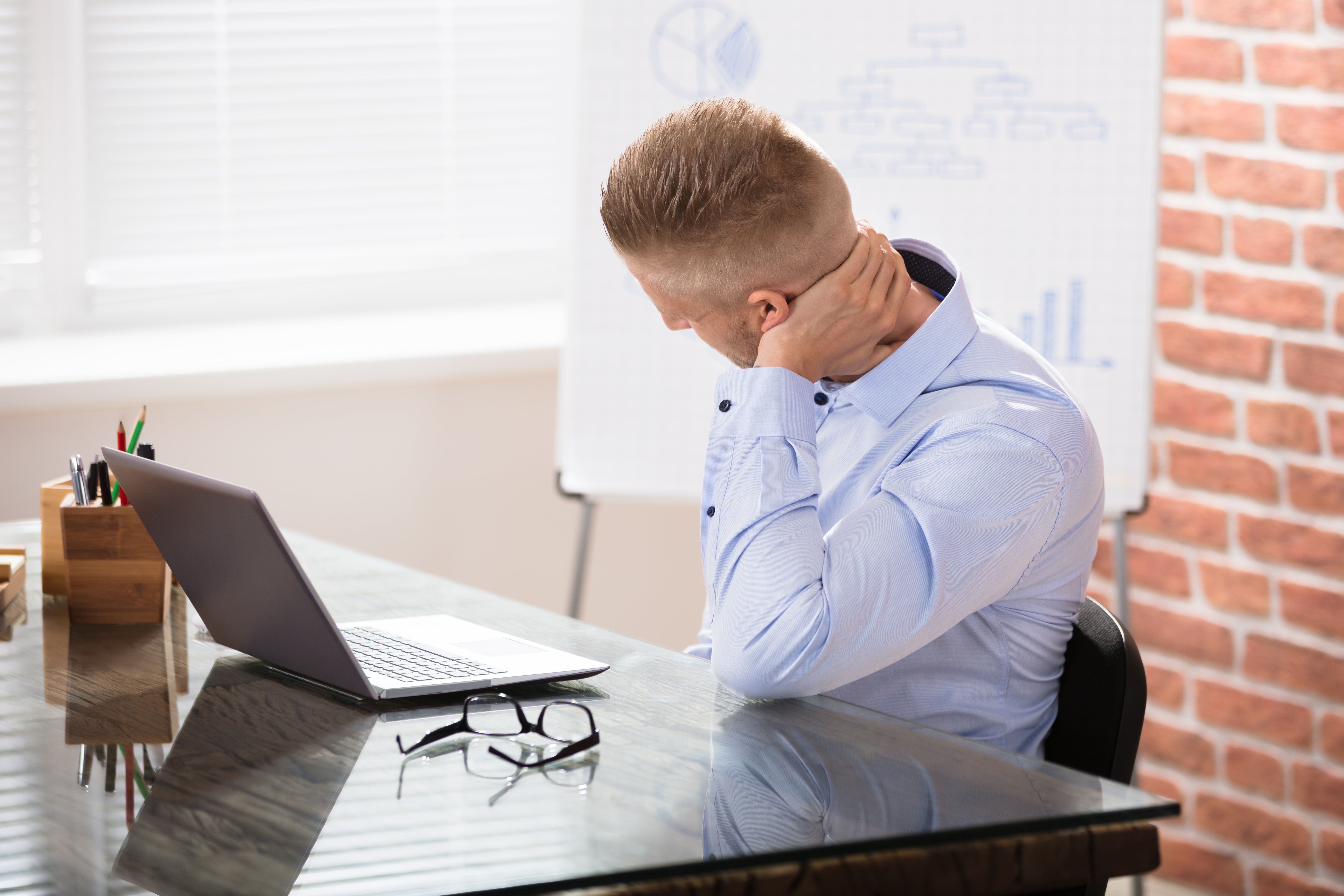 Man with neck pain from bad computer posture